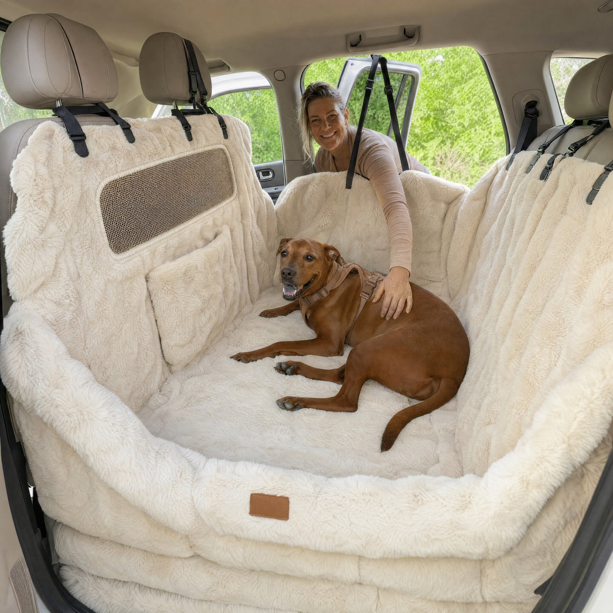 Dog lying on a cream full backseat protector with raised side bolsters