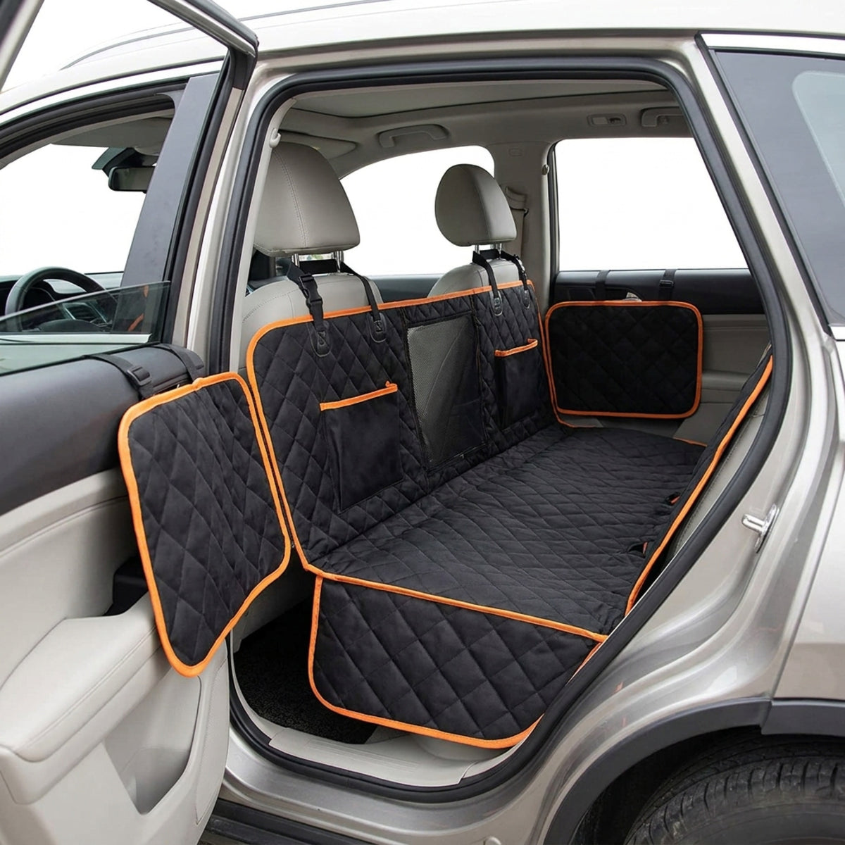 Side view of the black quilted hammock seat cover with both fold-out flaps covering the door panels and storage pockets on the rear panel