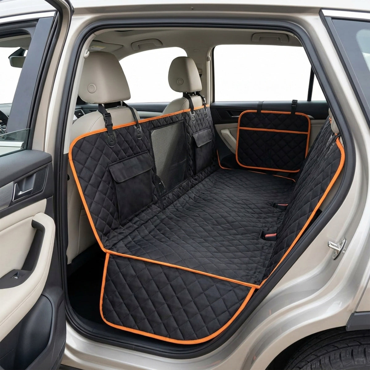 Black quilted waterproof hammock seat cover with orange trim installed across an SUV back bench, side flaps covering the door panels and a mesh window in the rear panel